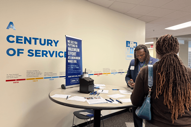 Volunteer helps with mock interviews at career fair