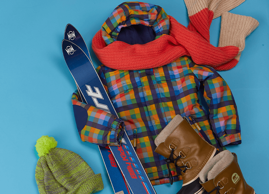 A coat, scarf, hat, boots and skis