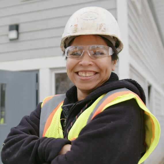 woman standing in front of a house