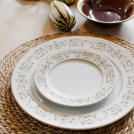 Two plates stacked on top of each other with a wicker placemat underneath